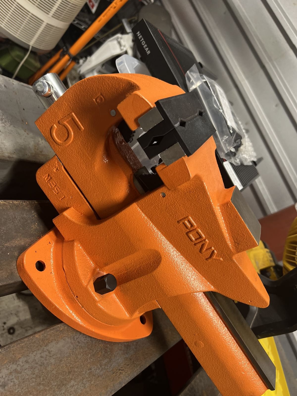 Pony 5-inch bench vise in orange with serrated jaw faces, pipe jaws and swivel base, in Rick's shop